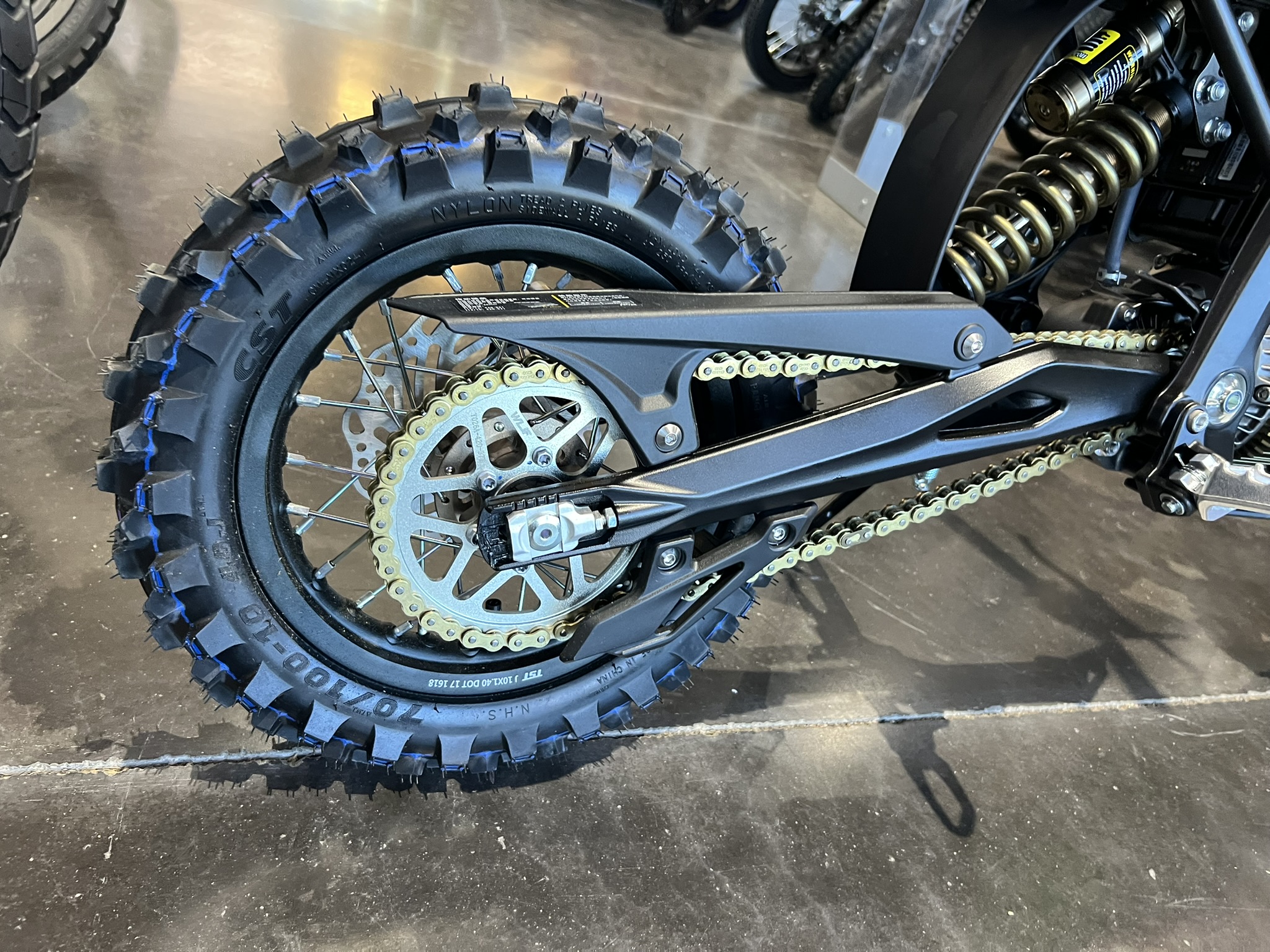 blue surron hyper bee green rear wheel and chain