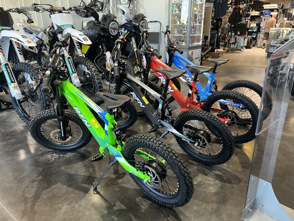 green and blue electric 18" bike with billet pegs